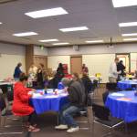 Volunteers and clients enjoy hot meals together during Project Homeless Connect at the Soldotna Regional Sports Complex on Wednesday, Jan. 23, 2019. (Photo by Brian Mazurek/Peninsula Clarion)