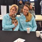 Gail Kennedy, left, Jennifer Waller, and Meiko, the therapy dog from Freedom House, offer their services during Project Homeless Connect at the Soldotna Regional Sports Complex on Wednesday, Jan. 23, 2019. (Photo by Brian Mazurek/Peninsula Clarion)