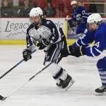 Soldotnas Wyatt Medcoff (left) attempts to clear the puck from Palmers Alex Nelius Thursday at the Soldotna Regional Sports Complex. (Photo by Joey Klecka/Peninsula Clarion)