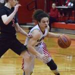 Kenais Tyrone McEnerney (right) drives the lane against Houstons Cody Wyrick Saturday afternoon at Kenai Central High School. (Photo by Joey Klecka/Peninsula Clarion)