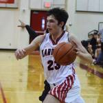 Kenais Adam Trujillo drives into the paint Saturday afternoon against the Houston Hawks at Kenai Central High School. (Photo by Joey Klecka/Peninsula Clarion)