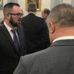 Department of Administration Commissioner Designee John Quick, left, speaks with senators after talking to the Senate Finance Committee on Tuesday, Jan. 22, 2019. (Alex McCarthy | Juneau Empire)