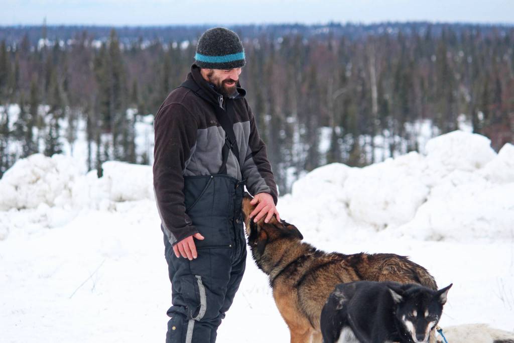 Musher Cim Smyth gives one of his dogs a pat just after finishing this years Tustumena 200 Sled Dog Race on Sunday, Jan. 27, 2019 at Freddies Roadhouse near Ninilchik, Alaska. (Photo by Megan Pacer/Homer News)