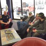 Lt. Ben Langham of the Kenai Police Department shares a laugh with members of the community at Ammo Can Coffee in Soldotna on Wednesday. (Photo by Brian Mazurek/Peninsula Clarion)