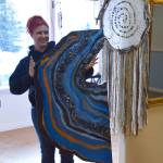 Local artist Audrey Cucullu shows off her latest piece at the Positive Vibe gallery in Kenai on Wednesday, Jan. 30, 2019. (Photo by Brian Mazurek/Peninsula Clarion)