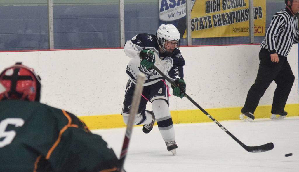 Soldotnas Gavin Haakenson unloads a shot on Delta goalie Robert Hanson Thursday at the Div. II state hockey championship tournament in Wasilla. (Photo by Joey Klecka/Peninsula Clarion)