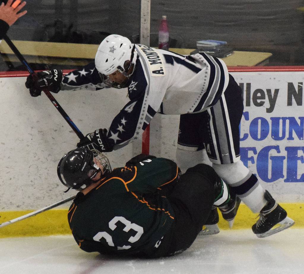 Soldotnas Alex Montague and Deltas Carter Richard collide Thursday at the Div. II state hockey championship tournament in Wasilla. (Photo by Joey Klecka/Peninsula Clarion)
