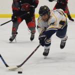 Homers Ethan Pitzman dives for a loose puck Thursday against Glennallen at the Div. II state hockey championship tournament in Wasilla. (Photo by Joey Klecka/Peninsula Clarion)
