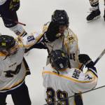 Homers Aiden Ross (middle) receives congratulations from teammates Thursday after scoring against Glennallen at the Div. II state hockey championship tournament in Wasilla. (Photo by Joey Klecka/Peninsula Clarion)