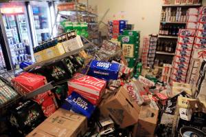 This Nov. 30, 2018 file photo shows cases of beer jumbled in a walk-in cooler at Value Liquor after an earthquake in Anchorage. (AP Photo/Dan Joling, File)