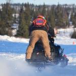 Will Hubler accelerates off the start line Saturday afternoon at the snowmachine drag races at Freddies Roadhouse near Ninilchik. (Photo by Joey Klecka/Peninsula Clarion)