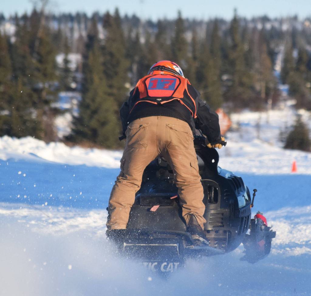 Will Hubler accelerates off the start line Saturday afternoon at the snowmachine drag races at Freddies Roadhouse near Ninilchik. (Photo by Joey Klecka/Peninsula Clarion)