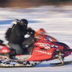 Freddie Pollard Jr. (front) races fellow competitor George Derkevorkian in a heat race Saturday afternoon at the snowmachine drag races at Freddies Roadhouse near Ninilchik. (Photo by Joey Klecka/Peninsula Clarion)