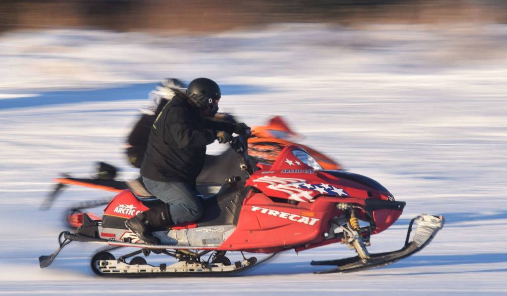 Freddie Pollard Jr. (front) races fellow competitor George Derkevorkian in a heat race Saturday afternoon at the snowmachine drag races at Freddies Roadhouse near Ninilchik. (Photo by Joey Klecka/Peninsula Clarion)