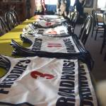 Piles of racing bibs wait to be claimed by contestants Saturday afternoon at the snowmachine drag races at Freddies Roadhouse near Ninilchik. (Photo by Joey Klecka/Peninsula Clarion)