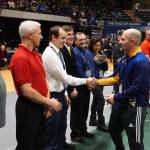 Homer High School Athletic Director Chis Perk, right in blue, is inducted into the Alaska Wrestling Hall of Fame on Dec. 15, 2018 at the Alaska Airlines Center in Anchorage, Alaska. (Photo courtesy Alaska Schools Activity Association)