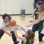 Sewards Sophia Dow passes under pressure from Soldotnas Ituau Tuisaula and Danica Schmidt on Friday, Jan. 11, 2019, at Soldotna High School. (Photo by Jeff Helminiak/Peninsula Clarion)