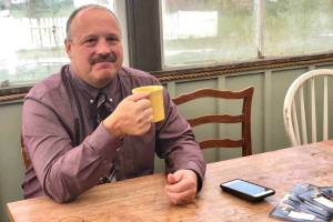 Kenai Peninsula Borough School District Superintendent Sean Dusek waits to talk and answer the publics questions in the back room of Veronicas Cafe in Kenai on Friday. (Photo by Victoria Petersen/Peninsula Clarion)