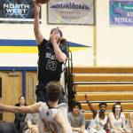 Soldotna High Schools David Michael bolls over Homers Seth Adkins while taking a shot during a Tuesday, Jan. 15, 2019 game in Homer, Alaska. (Photo by Megan Pacer/Homer News)