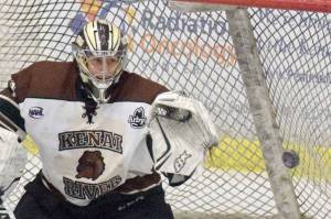 Kenai River Brown Bears goalie Gavin Enright tracks the puck for a save as defenseman Connor Scahill looks on Friday, Nov. 3, 2018, at the Soldotna Regional Sports Complex. (Photo by Jeff Helminiak/Peninsula Clarion)