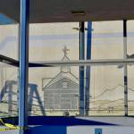 After construction workers removed siding from the facade of the Kenai Municipal Airport, a mural with iconic Kenai images like fishing nets, the St. Nicholas Russian Orthodox chapel and a dog musher, was revealed on Tuesday, Jan. 15, 2019 in Kenai, Alaska.(Photo by Victoria Petersen/Peninsula Clarion)