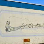 After construction workers removed siding from the facade of the Kenai Municipal Airport, a mural with iconic Kenai images like fishing nets, the St. Nicholas Russian Orthodox chapel and a dog musher, was revealed on Tuesday, Jan. 15, 2019 in Kenai, Alaska.(Photo by Victoria Petersen/Peninsula Clarion)