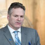 Gov. Mike Dunleavy announces two bills to pay back residents cut PFD funds during a press conference at the Capitol on Wednesday. (Michael Penn/Juneau Empire)