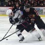 Kenais Aidan Milburn (right) and Soldotnas Dylan Walton fight for the puck Wednesday night in a conference game at the Soldotna Regional Sports Complex. (Photo by Joey Klecka/Peninsula Clarion)
