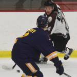 Kenai Rivers Zach Krajnik looks for a way around Springfields Blake Finley (front) Thursday night in a North American Hockey League contest against the Springfield (Illinois) Jr. Blues at the Soldotna Regional Sports Complex. (Photo by Joey Klecka/Peninsula Clarion)