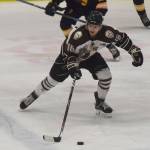 Kenai Rivers Andy Walker looks for an open teammate Thursday night in a North American Hockey League contest against the Springfield (Illinois) Jr. Blues at the Soldotna Regional Sports Complex. (Photo by Joey Klecka/Peninsula Clarion)