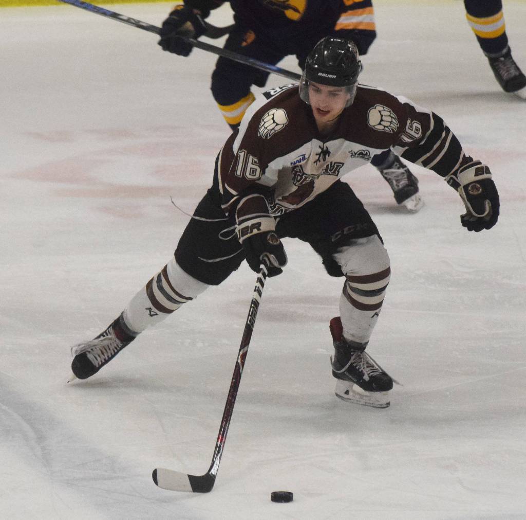 Kenai Rivers Andy Walker looks for an open teammate Thursday night in a North American Hockey League contest against the Springfield (Illinois) Jr. Blues at the Soldotna Regional Sports Complex. (Photo by Joey Klecka/Peninsula Clarion)