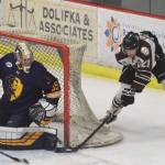 Kenai Rivers Brendan White (right) tries a wraparound shot on Springfield goalie Jack Williams, Thursday night in a North American Hockey League contest against the Springfield (Illinois) Jr. Blues at the Soldotna Regional Sports Complex. (Photo by Joey Klecka/Peninsula Clarion)