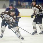 Kenai River Brown Bears forward Zach Krajnik skates in front of Giovanni Carabelli of the Springfield (Illinois) Jr. Blues on Friday, Jan. 18, 2019, at the Soldotna Regional Sports Complex. (Photo by Jeff Helminiak/Peninsula Clarion)