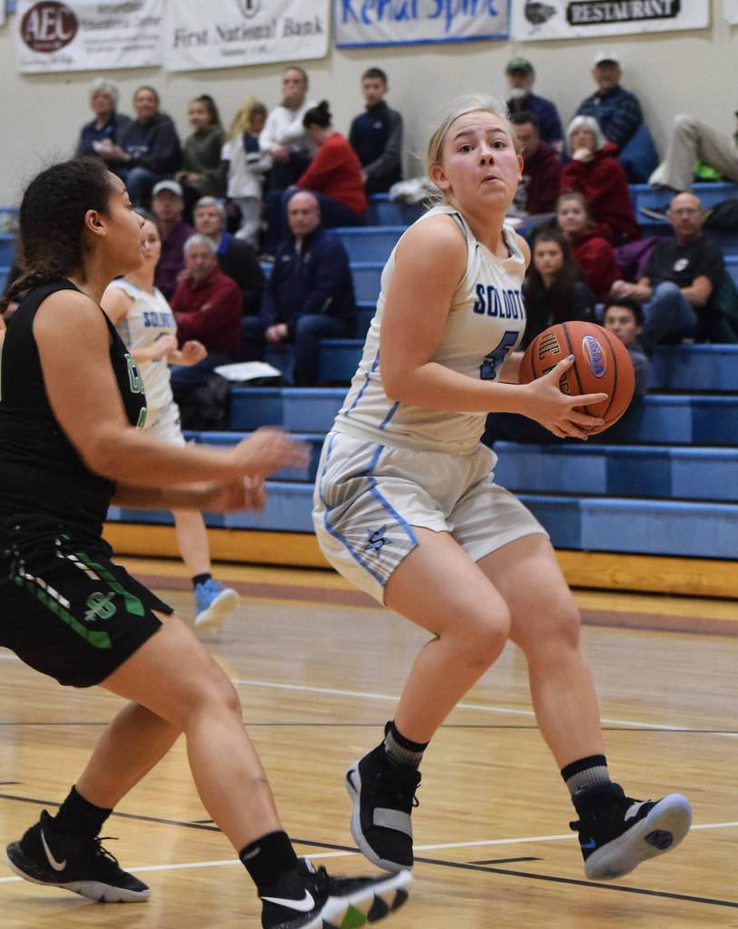 Soldotnas Brittani Blossom (right) drives into the paint Friday night at Soldotna High School. (Photo by Joey Klecka/Peninsula Clarion)