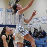 Soldotnas Aliann Schmidt lays in a bucket Friday night over Colonys Vivian Sonnenberg at Soldotna High School. (Photo by Joey Klecka/Peninsula Clarion)