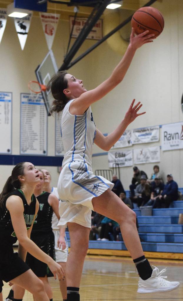 Soldotnas Aliann Schmidt lays in a bucket Friday night over Colonys Vivian Sonnenberg at Soldotna High School. (Photo by Joey Klecka/Peninsula Clarion)