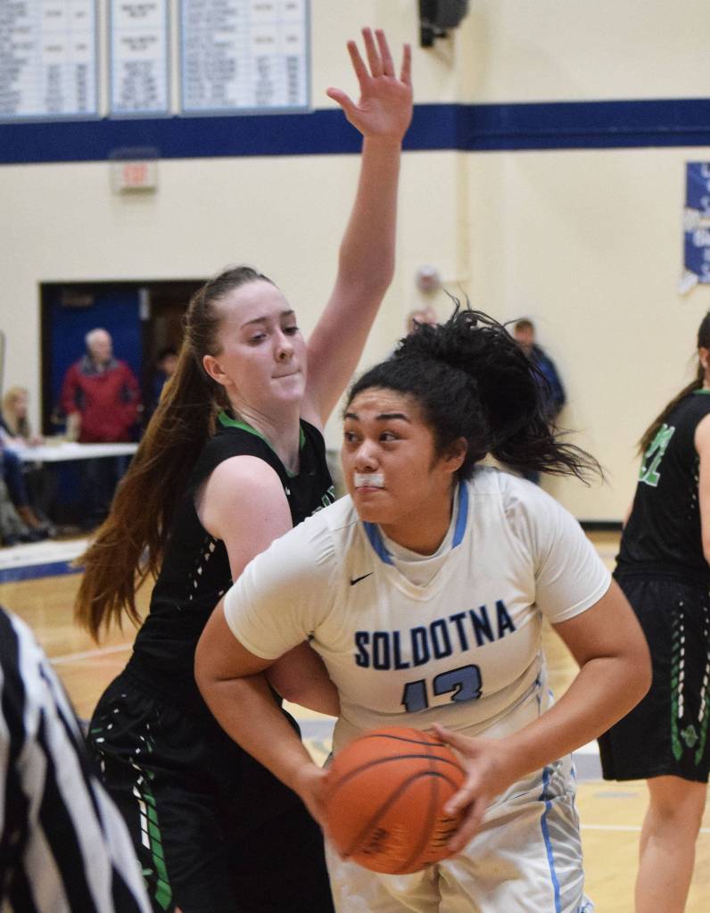 Soldotnas Ituau Tuisaula darts around Colonys Tori Schwantes Friday night at Soldotna High School. (Photo by Joey Klecka/Peninsula Clarion)