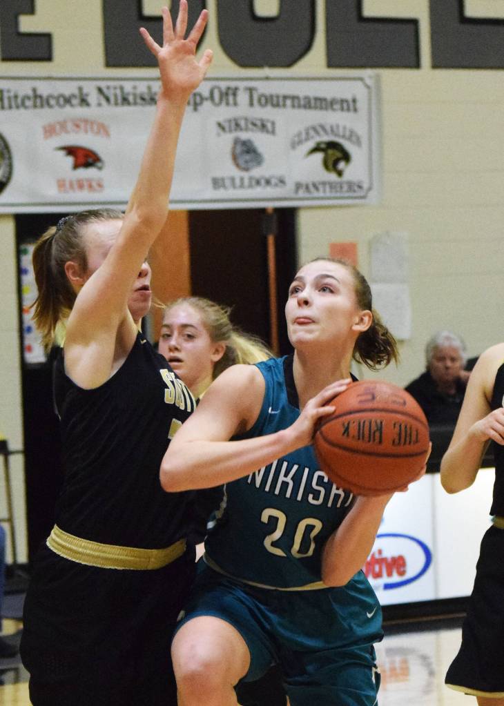 Nikiskis Bethany Carstens (20) looks for a shot against Souths Maris Soland Saturday at the Rus Hitchcock Nikiski Tip Off tournament. (Photo by Joey Klecka/Peninsula Clario¡n)