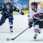 Juneau-Douglas Kyler Alderfer, right, moves the puck in front of Homers Casey Otis at Treadwell Arena on Friday, Jan. 18, 2019. JDHS won 4-3 in overtime. (Michael Penn | Juneau Empire)