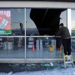 In this Nov. 30, 2018, file photo, Dennis Keeling, of Instant Services, measures for a broken window at an auto parts store following an earthquake in Anchorage, Alaska Seven weeks after the massive earthquake struck Alaska, the seemingly endless aftershocks are keeping many residents filled with anxiety. (AP Photo/Mike Dinneen, file)