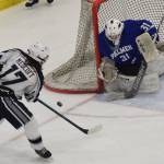 Palmer goalie Tiernan ORourke wards off a shot by Soldotnas Wyatt Medcoff Friday in a state semifinal contest at the Curtis Menard Sports Complex in Wasilla. (Photo by Joey Klecka/Peninsula Clarion)