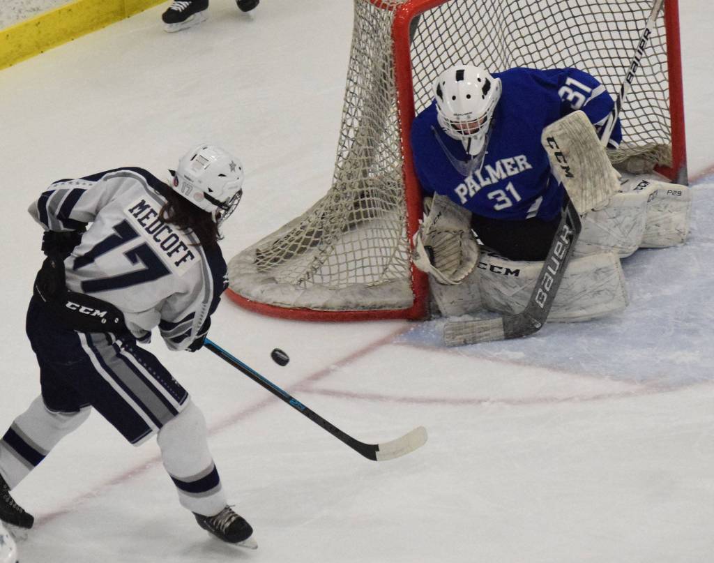 Palmer goalie Tiernan ORourke wards off a shot by Soldotnas Wyatt Medcoff Friday in a state semifinal contest at the Curtis Menard Sports Complex in Wasilla. (Photo by Joey Klecka/Peninsula Clarion)