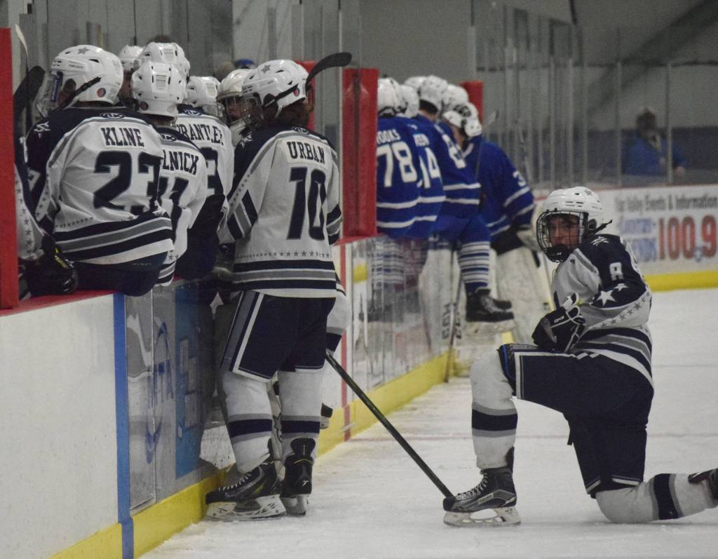 Soldotnas J.D. Schmelzenbach looks on as both teams huddle in a late timeout Friday in a state semifinal contest at the Curtis Menard Sports Complex in Wasilla. (Photo by Joey Klecka/Peninsula Clarion)