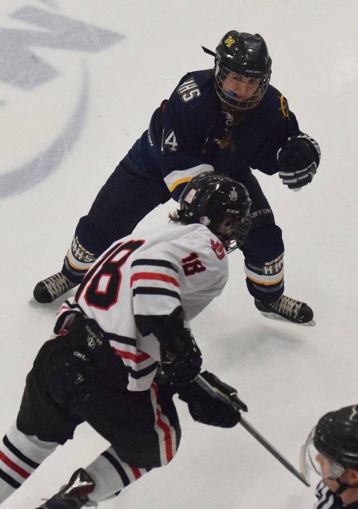 Homers Brenna McCarron blocks the path of Juneaus Dalton Hoy Friday in a Div. II state semifinal at the Curtis Menard Sports Complex in Wasilla. (Photo by Joey Klecka/Peninsula Clarion)