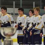Members of the Homer hockey team watch postgame ceremonies Saturday night after losing 6-5 in overtime to Palmer in the Div. II championshipat the Curtis Menard Sports Complex in Wasilla. (Photo by Joey Klecka/Peninsula Clarion)