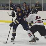 Homers Ethan Pitzman negotiates around Juneaus Ethan Welch Friday in a Div. II state semifinal at the Curtis Menard Sports Complex in Wasilla. (Photo by Joey Klecka/Peninsula Clarion)