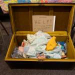 Quilter Jane Regan offered scraps of fabric from her mothers collection at the 9 Women / 9 Quilts show that opened last Friday, Feb. 1, 2019, at the Homer Council on the Arts, in Homer, Alaska. (Photo by Michael Armstrong/Homer News)