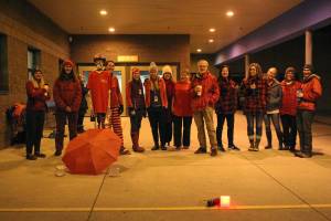 A group of teachers gather outside the entrance to West Homer Elementary and Big Fireweed Academy wearing red for ed Wednesday, in Homer. Teachers around the Kenai Peninsula demonstrated this week to bring awareness to the contract negotiation situation with the school district. (Photo by Megan Pacer/Homer News)