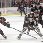 Brown Bears forward Andy Walker carries the puck between Corpus Christis Anthony Firriolo and Kyle Moore on Friday, Feb. 8, 2019, at the Soldotna Regional Sports Complex. (Photo by Jeff Helminiak/Peninsula Clarion)