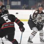 Kenai River Brown Bears defenseman Markuss Komuls flips the puck past Corpus Christi (Texas) IceRays defenseman Coltan Wilkie on Friday, Feb. 8, 2019, at the Soldotna Regional Sports Complex. (Photo by Jeff Helminiak/Peninsula Clarion)